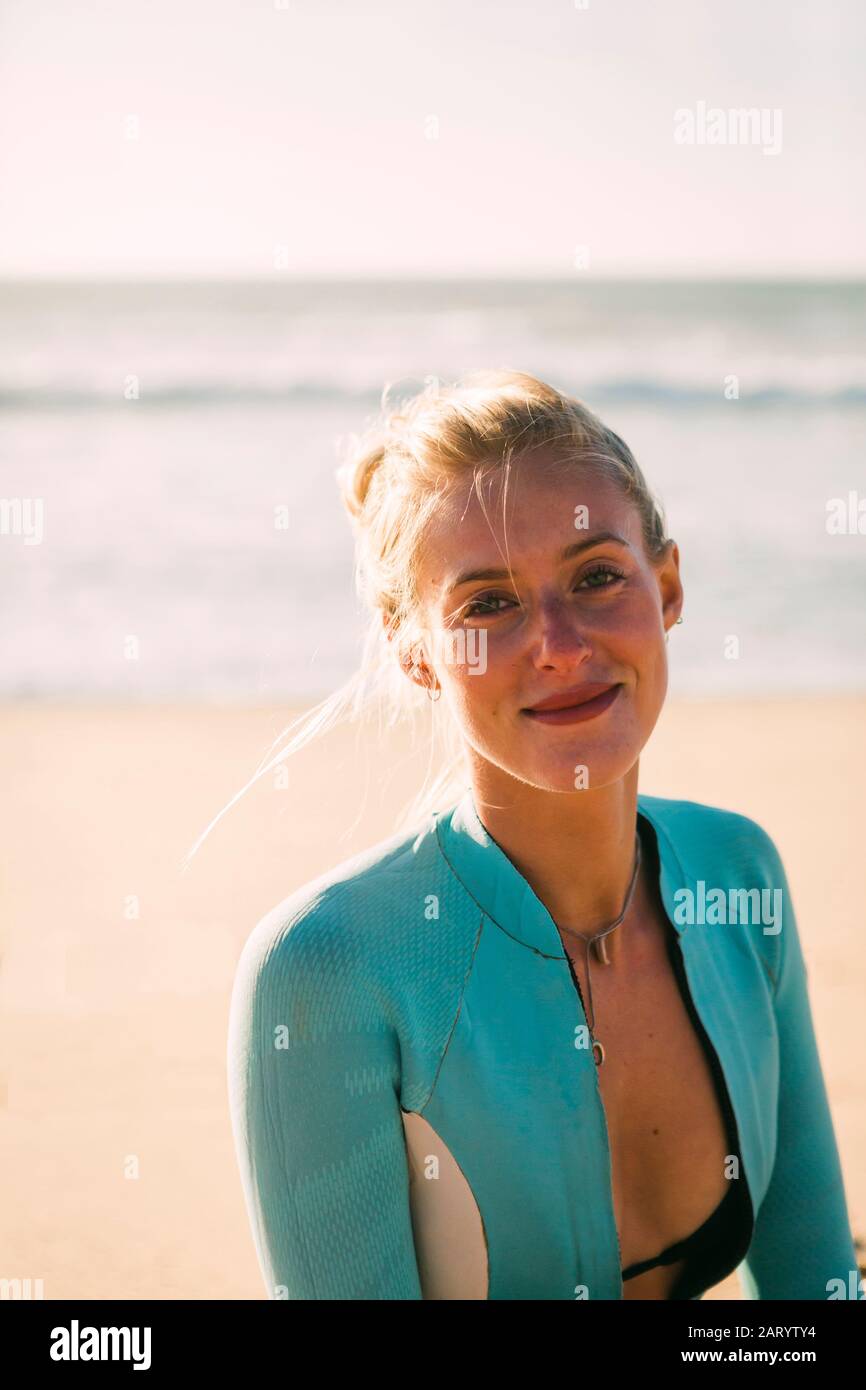 Portrait of woman wearing wetsuit at beach Stock Photo - Alamy