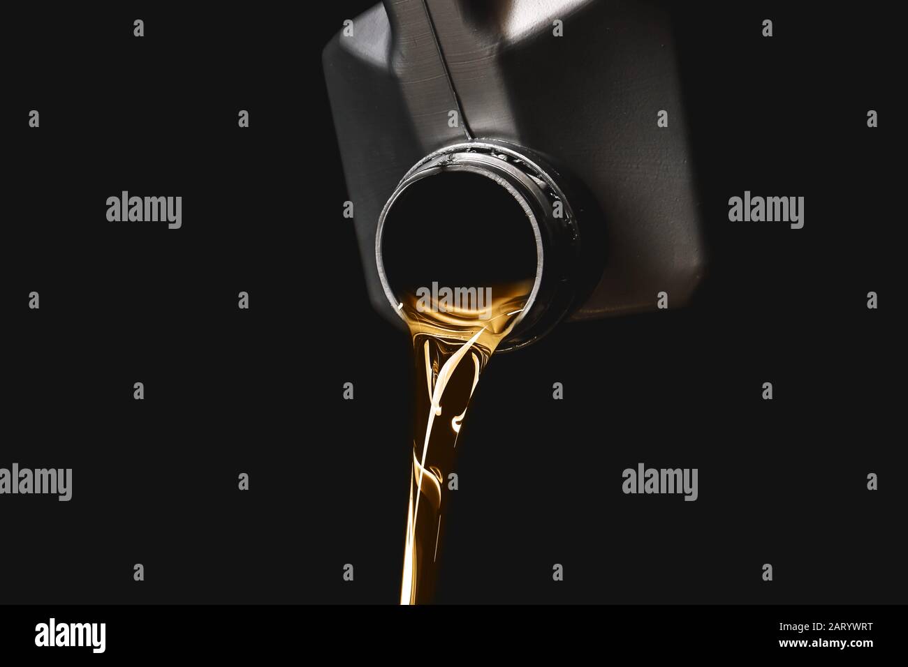 Can with pouring car oil on dark background Stock Photo - Alamy