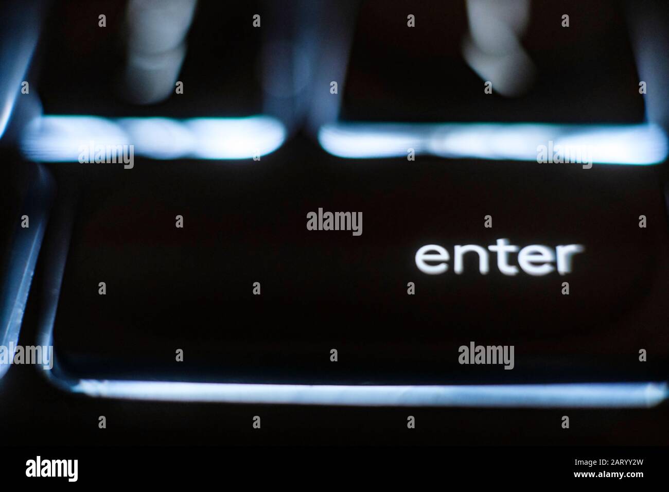 Illuminated 'enter' key on keyboard Stock Photo