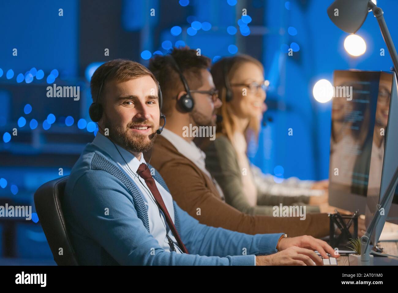 Technical support agents working in office at night Stock Photo - Alamy