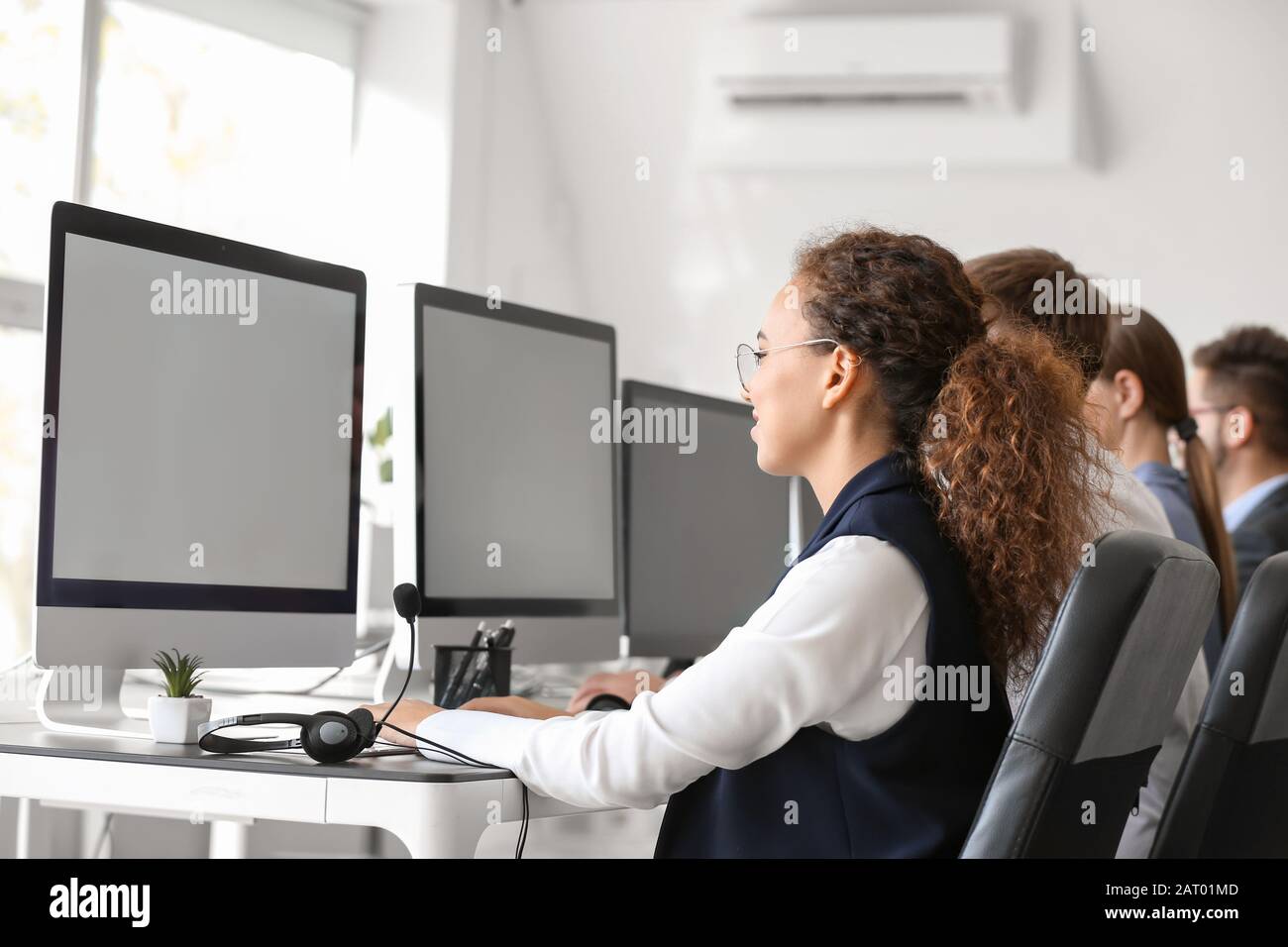 Technical support agents working in office Stock Photo - Alamy
