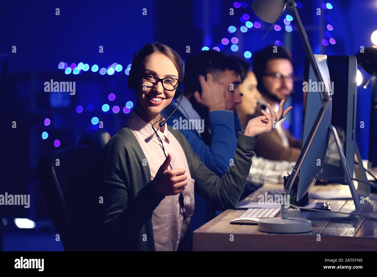 Technical support agents working in office at night Stock Photo