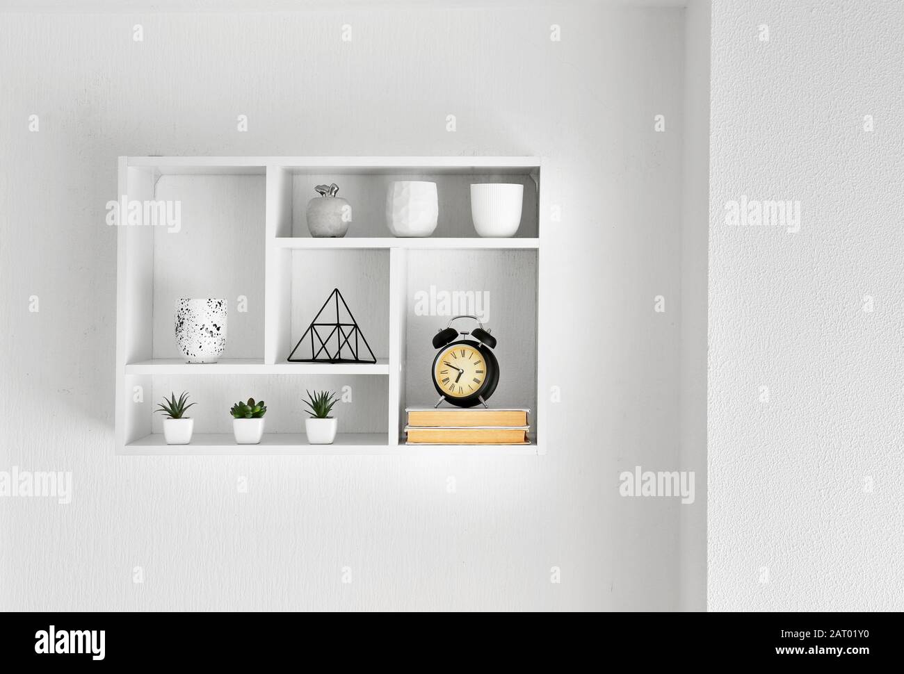 Shelf with decor hanging on white wall Stock Photo - Alamy