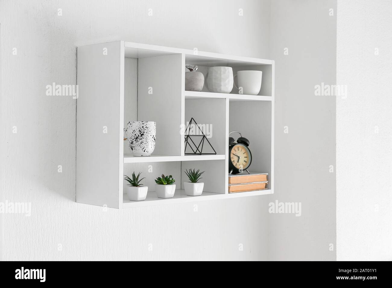Shelf with decor hanging on white wall Stock Photo - Alamy