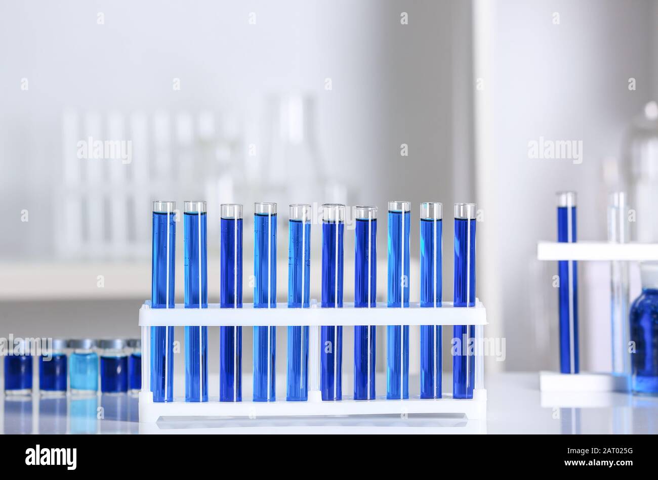 Test tubes with samples on table in laboratory Stock Photo - Alamy