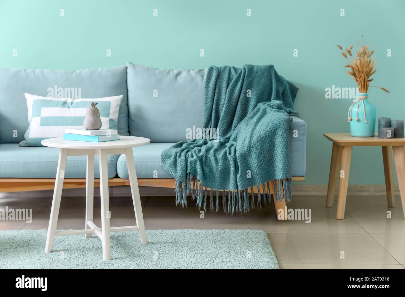 Stylish interior of living room in turquoise color Stock Photo - Alamy