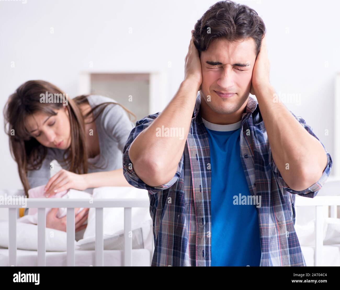Young dad cannot stand baby crying Stock Photo - Alamy