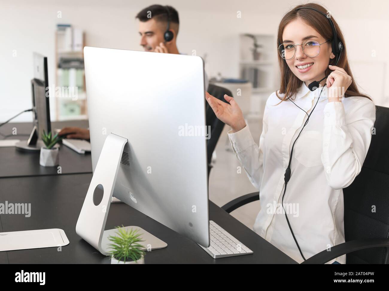 Female technical support agent working in office Stock Photo - Alamy