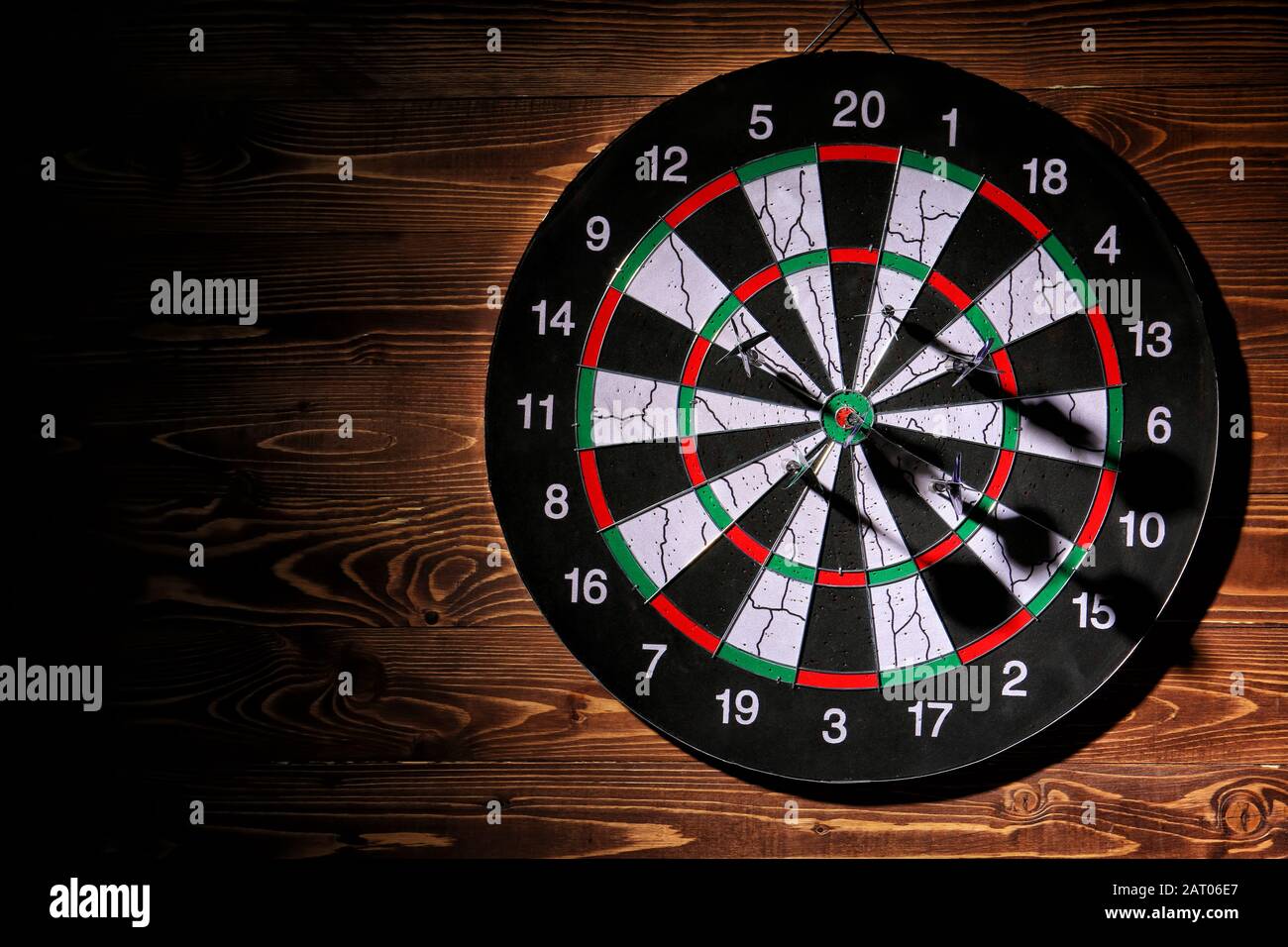 Dartboard hanging on wooden wall Stock Photo Alamy