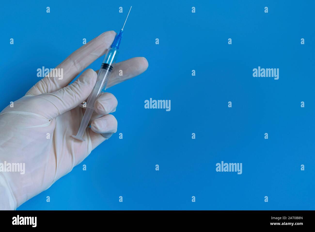 White disposable gloves, syringe with vaccine and medicine. Hygiene and protection against diseases and viruses. Coronavirus. Flu Stock Photo