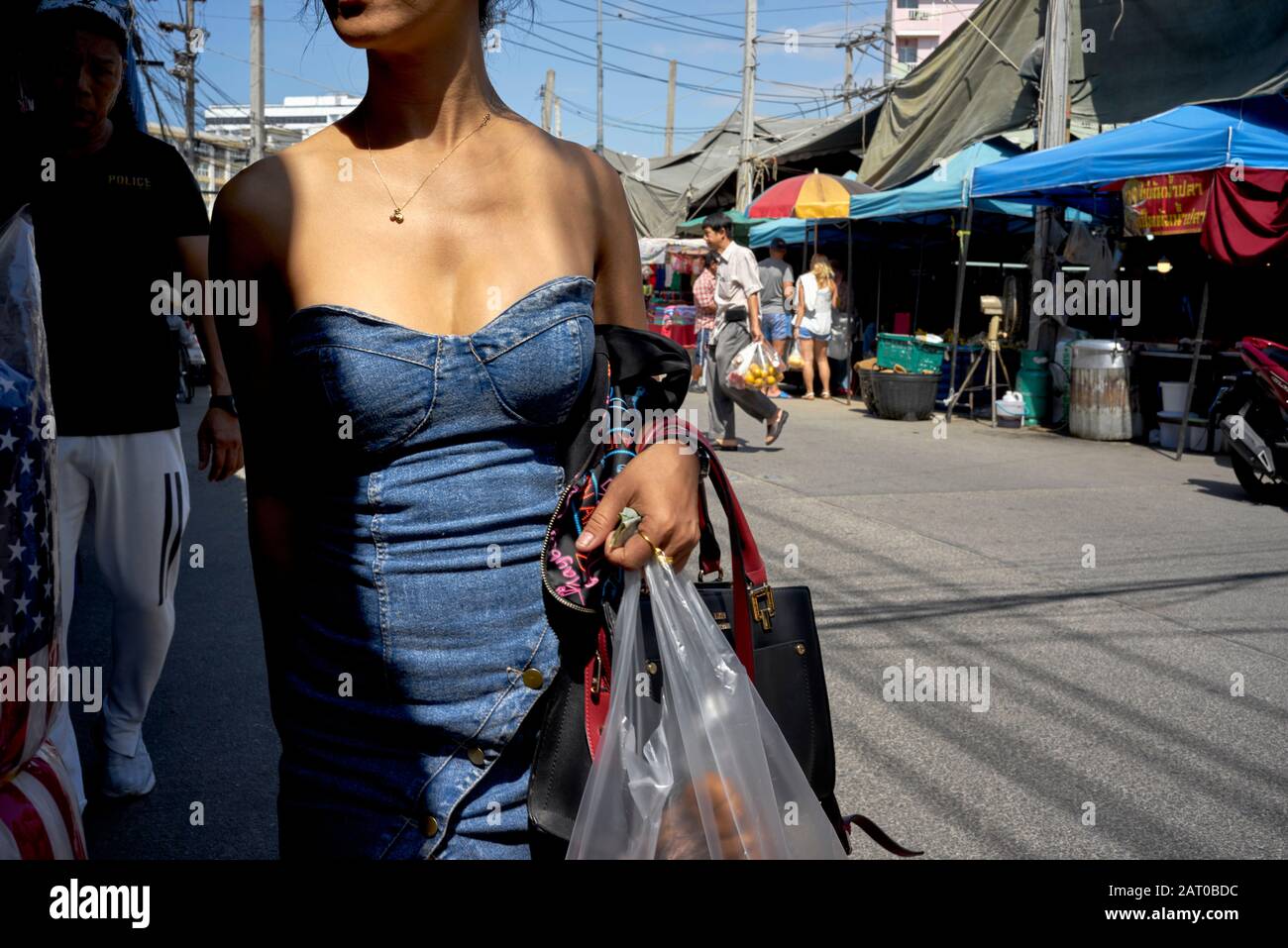 Denim dress; Woman wearing a strapless low cut denim dress Stock Photo