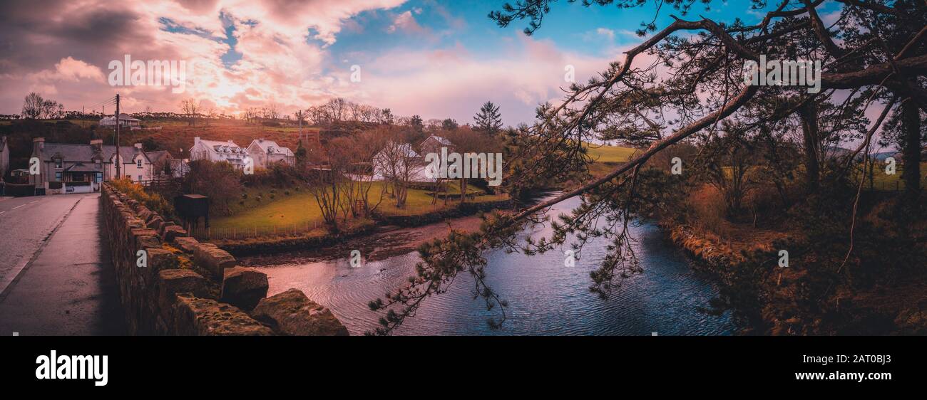 CUSHENDUN, NORTHERN IRELAND, DECEMBER 20, 2018: Beautiful panoramic view of Glendun River from over the bridge that cross it during sunset Stock Photo