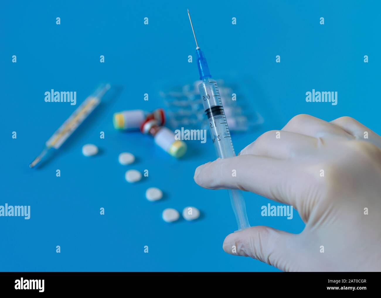 White disposable gloves, syringe with vaccine and medicine. Hygiene and protection against diseases and viruses. Coronavirus. Flu Stock Photo