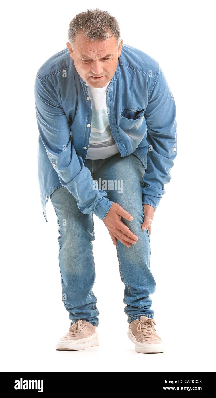 Mature man suffering from pain in knee on white background Stock Photo ...