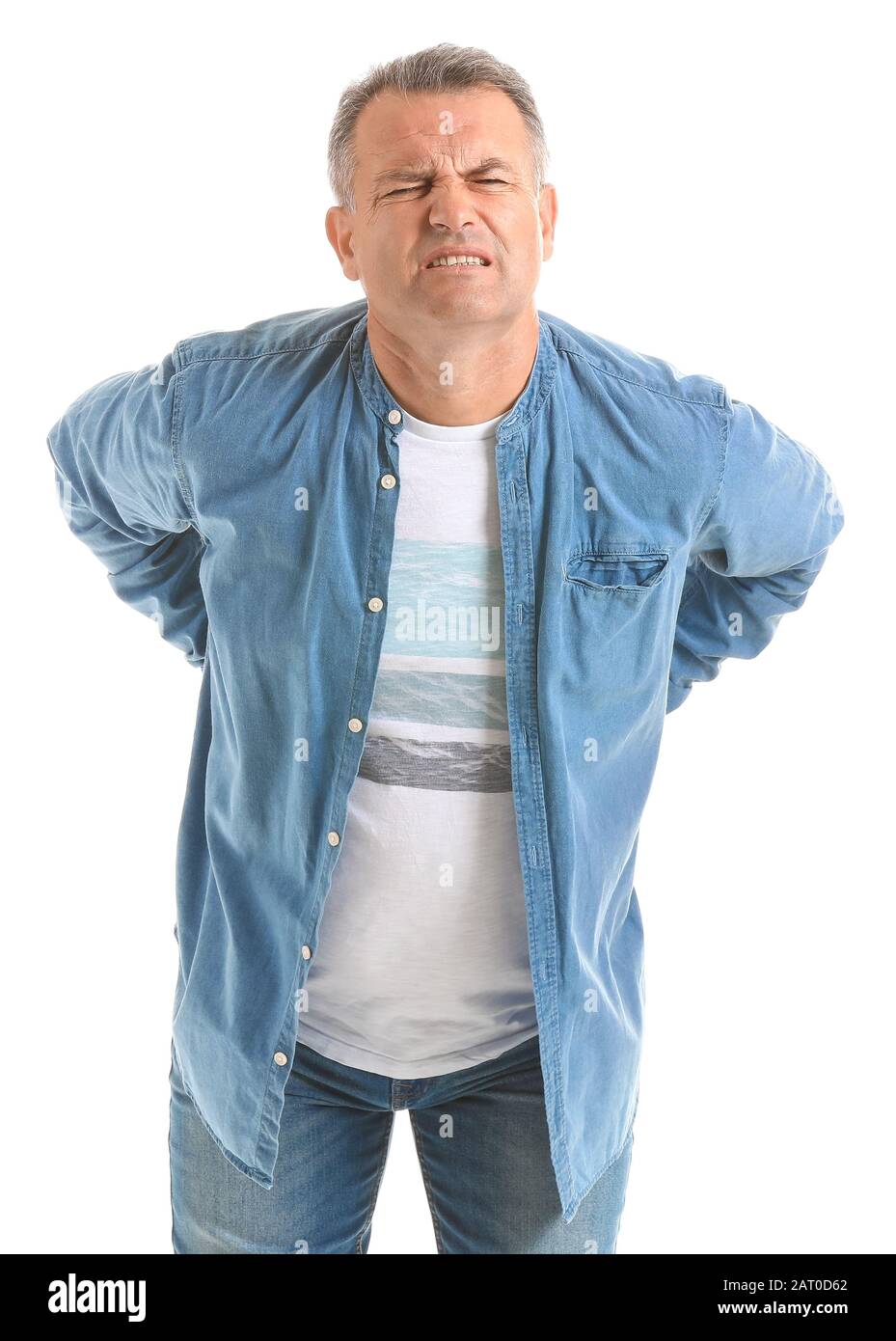 Mature man suffering from back pain on white background Stock Photo - Alamy