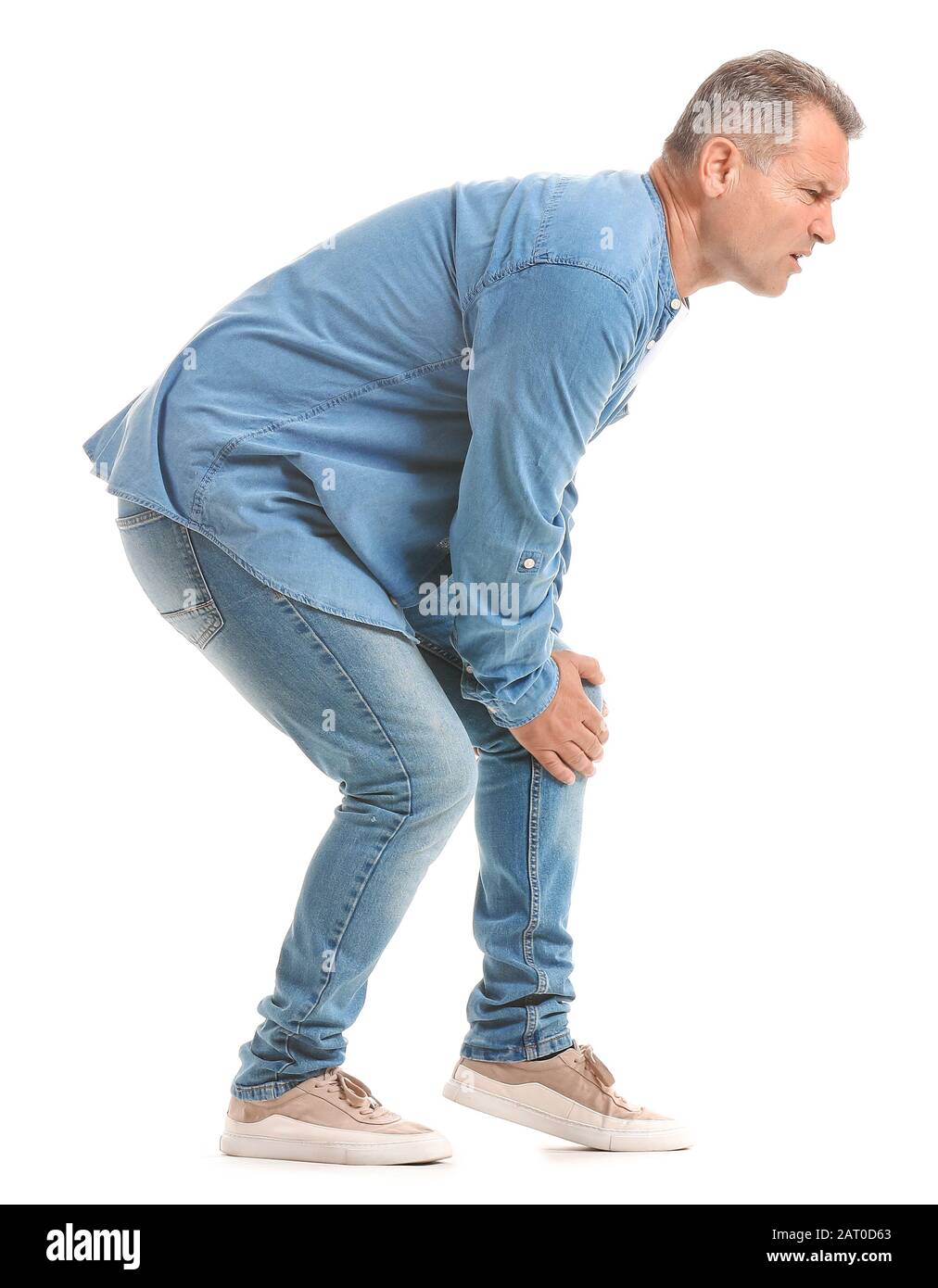 Mature man suffering from pain in knee on white background Stock Photo ...