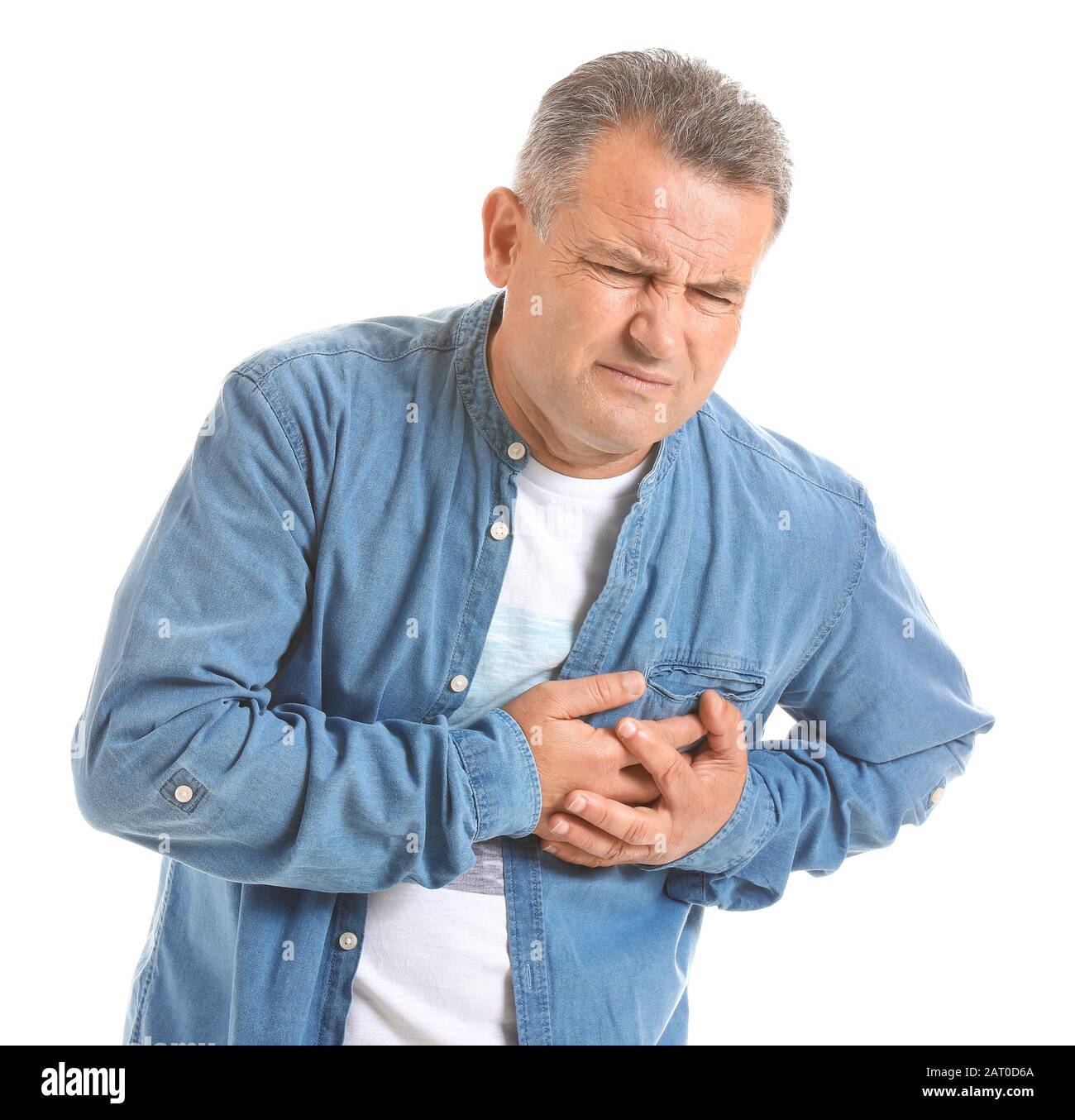 Mature man suffering from heart attack on white background Stock Photo ...