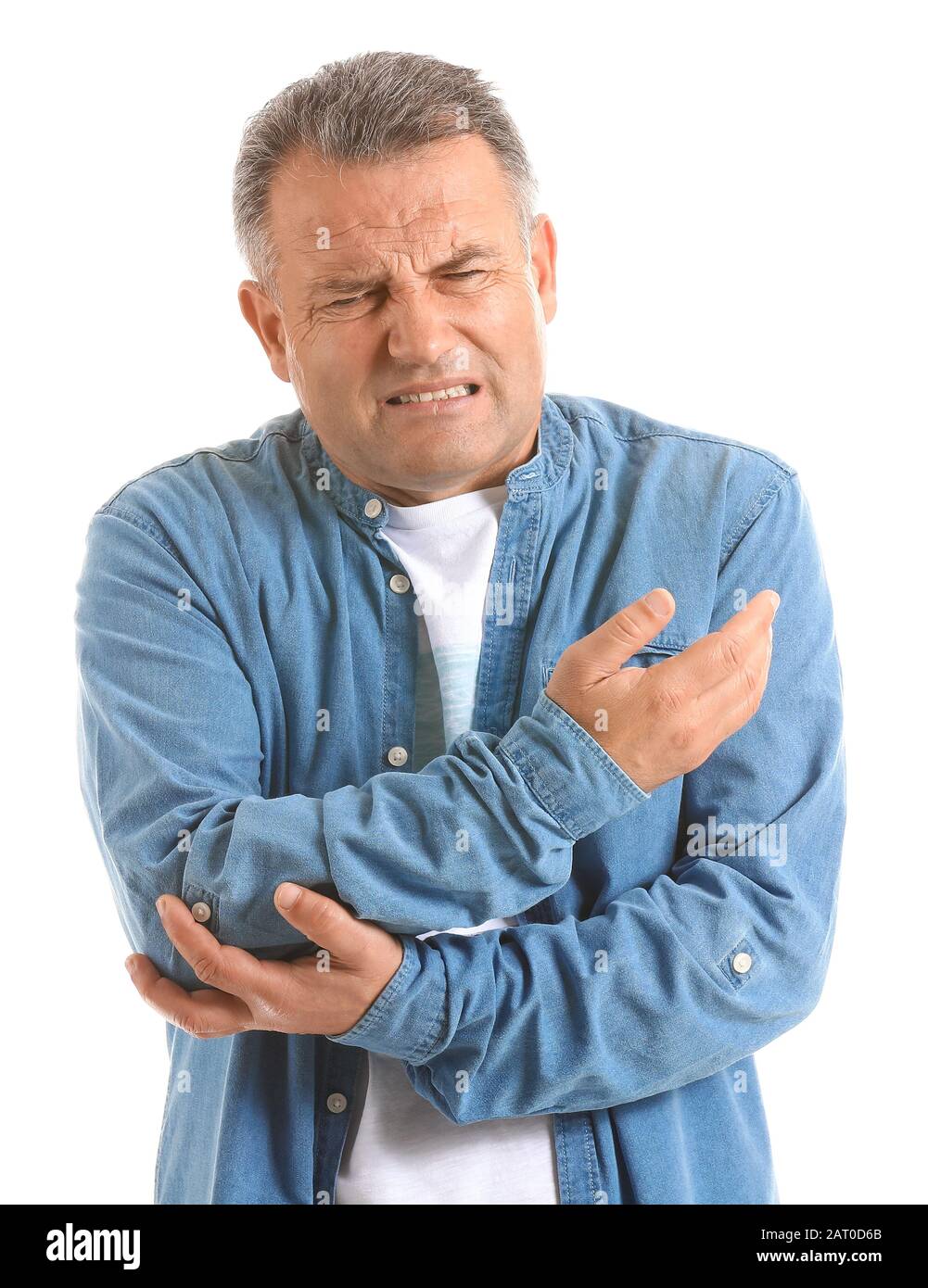 Mature man suffering from pain in elbow on white background Stock Photo ...