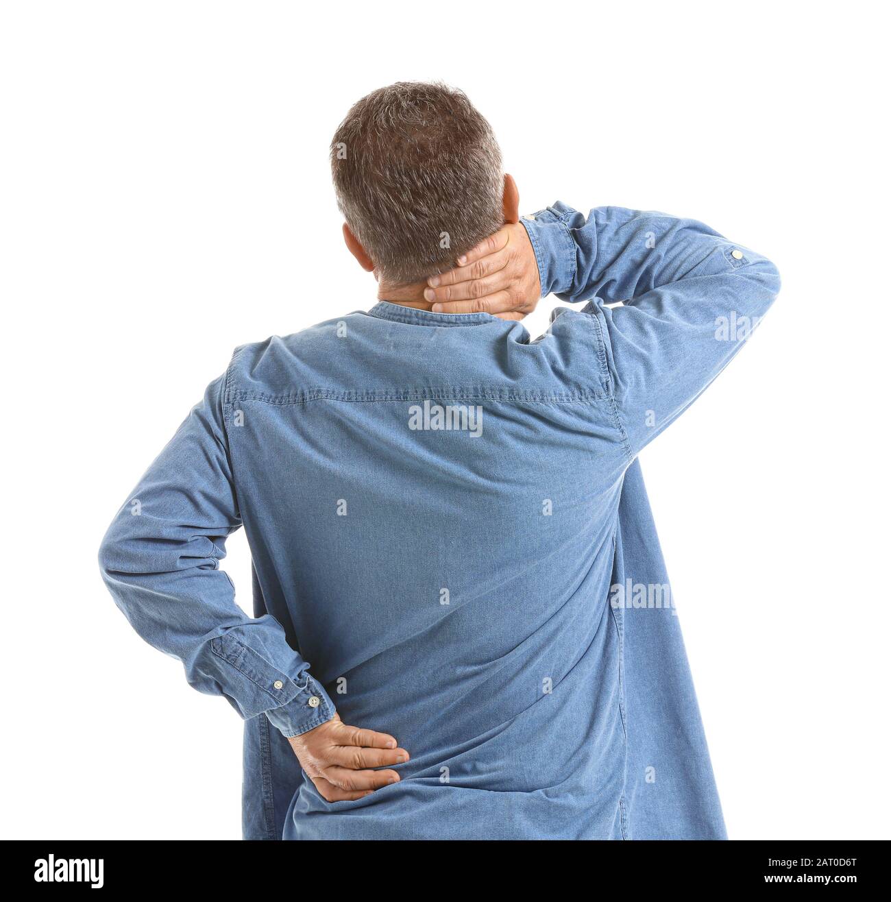 Mature man suffering from back pain on white background Stock Photo - Alamy