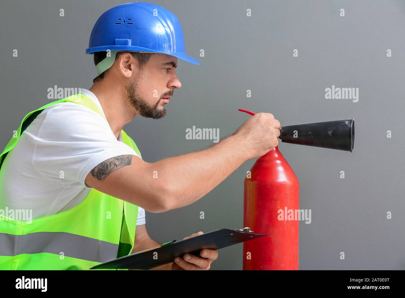 Fire safety specialist inspecting extinguisher Stock Photo Alamy