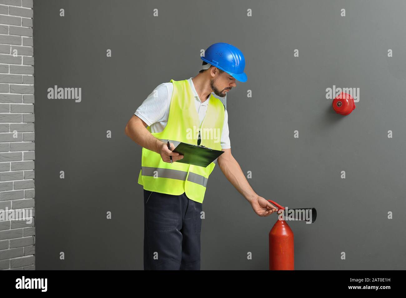 Fire safety specialist inspecting extinguisher Stock Photo Alamy