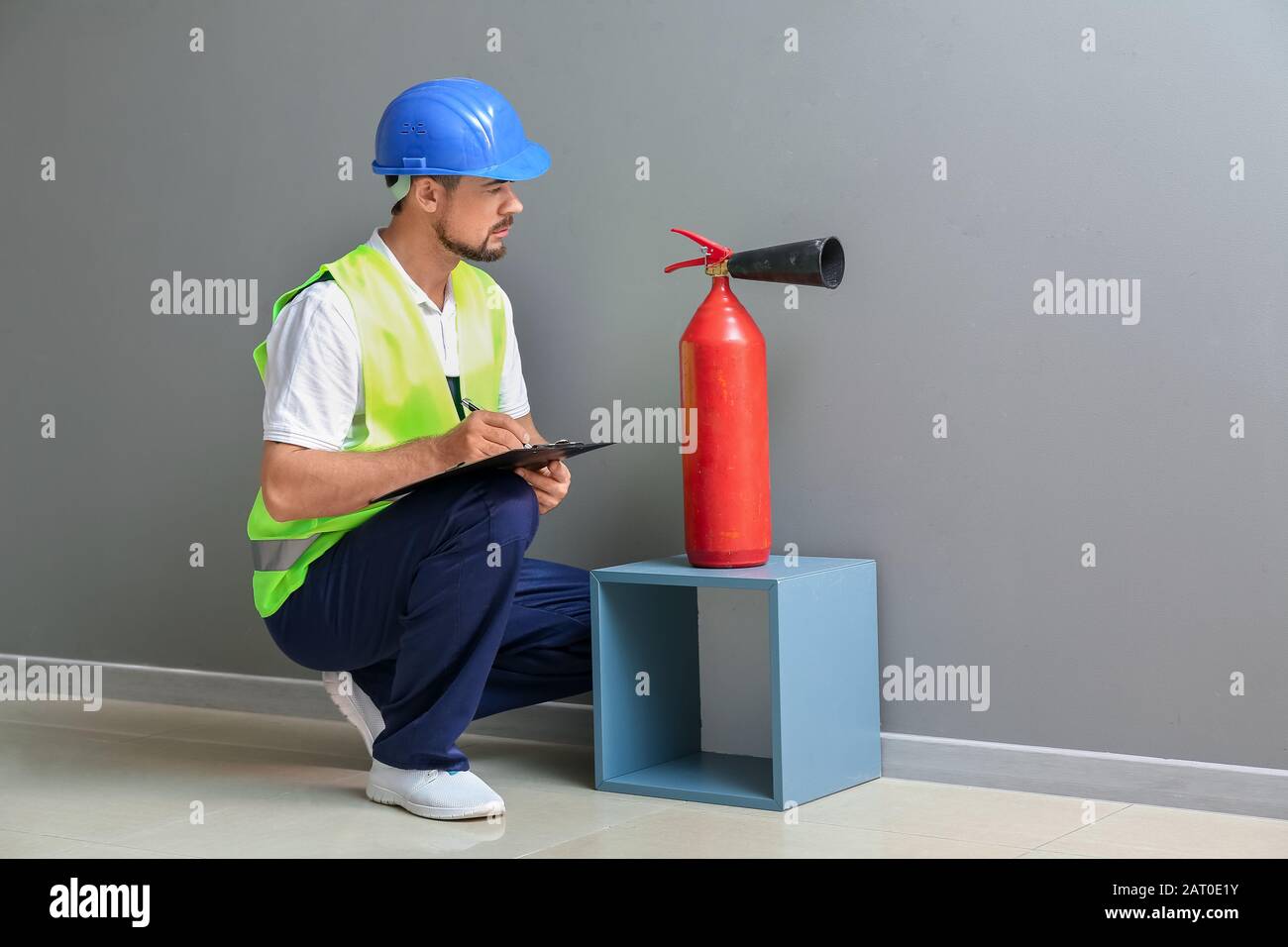 Fire safety specialist inspecting extinguisher Stock Photo Alamy