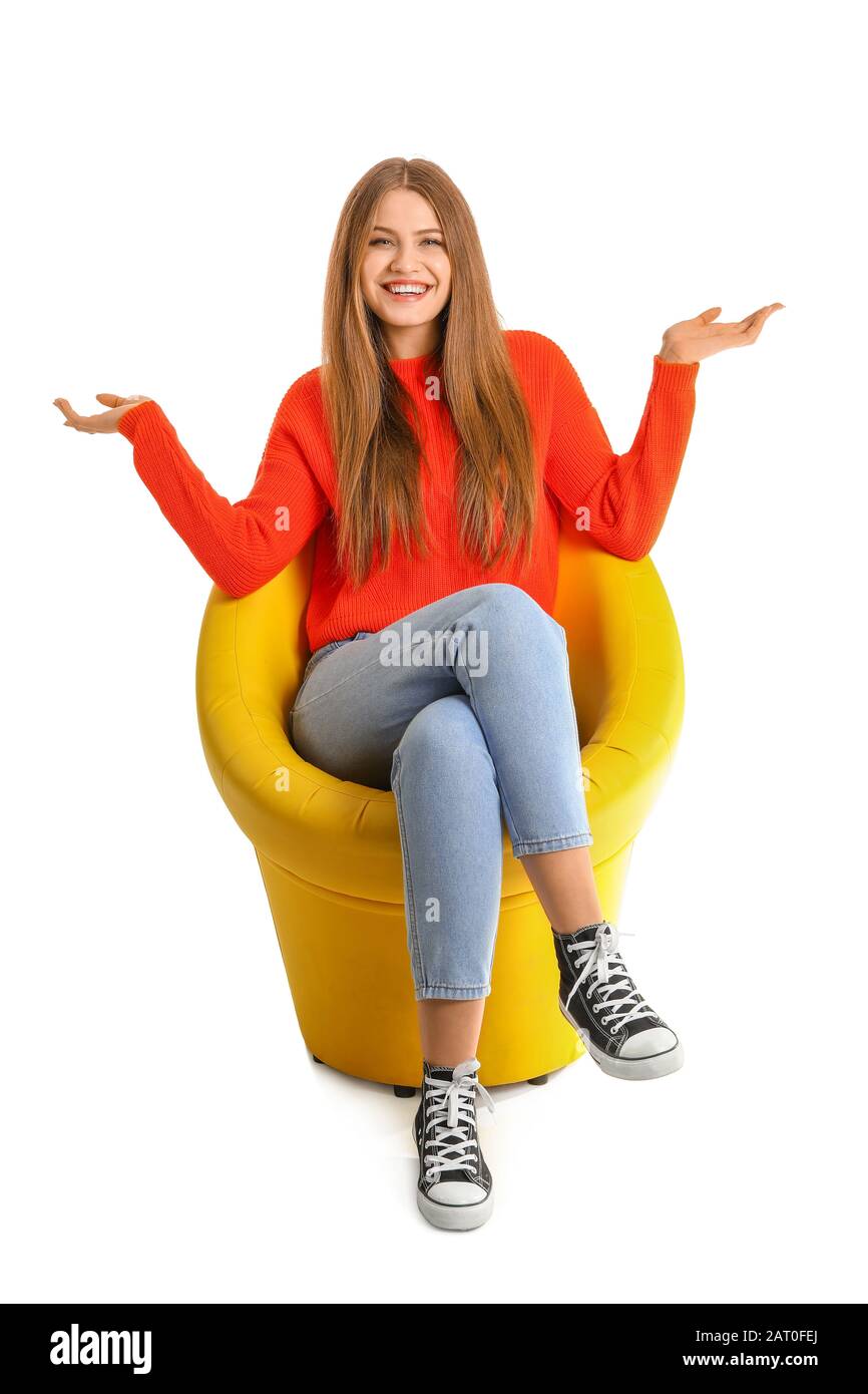 Beautiful woman sitting in armchair on white background Stock Photo - Alamy
