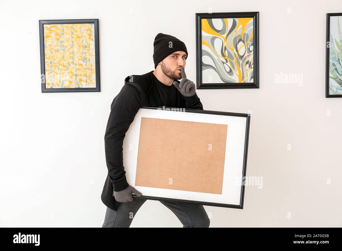 Thief stealing picture from art gallery Stock Photo Alamy