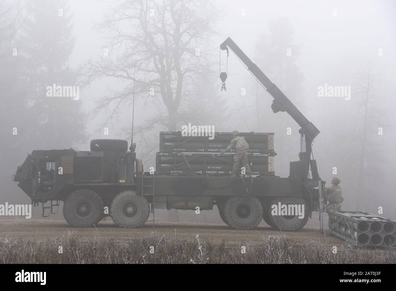 U.S. Soldiers, assigned to 1st Battalion, 6th Field Artillery Regiment, 41st Field Artillery Brigade, unload M270A1 Multiple Launch Rocket System (MLRS) rocket pod containers during a live-fire exercise at 7th Army Training Command's Grafenwoehr Training Area, Grafenwoehr, Germany, Jan. 27, 2020. This is the first live-fire exercise from a European based U.S. Army MLRS unit since 2004. (U.S. Army photo by Markus Rauchenberger) Stock Photo