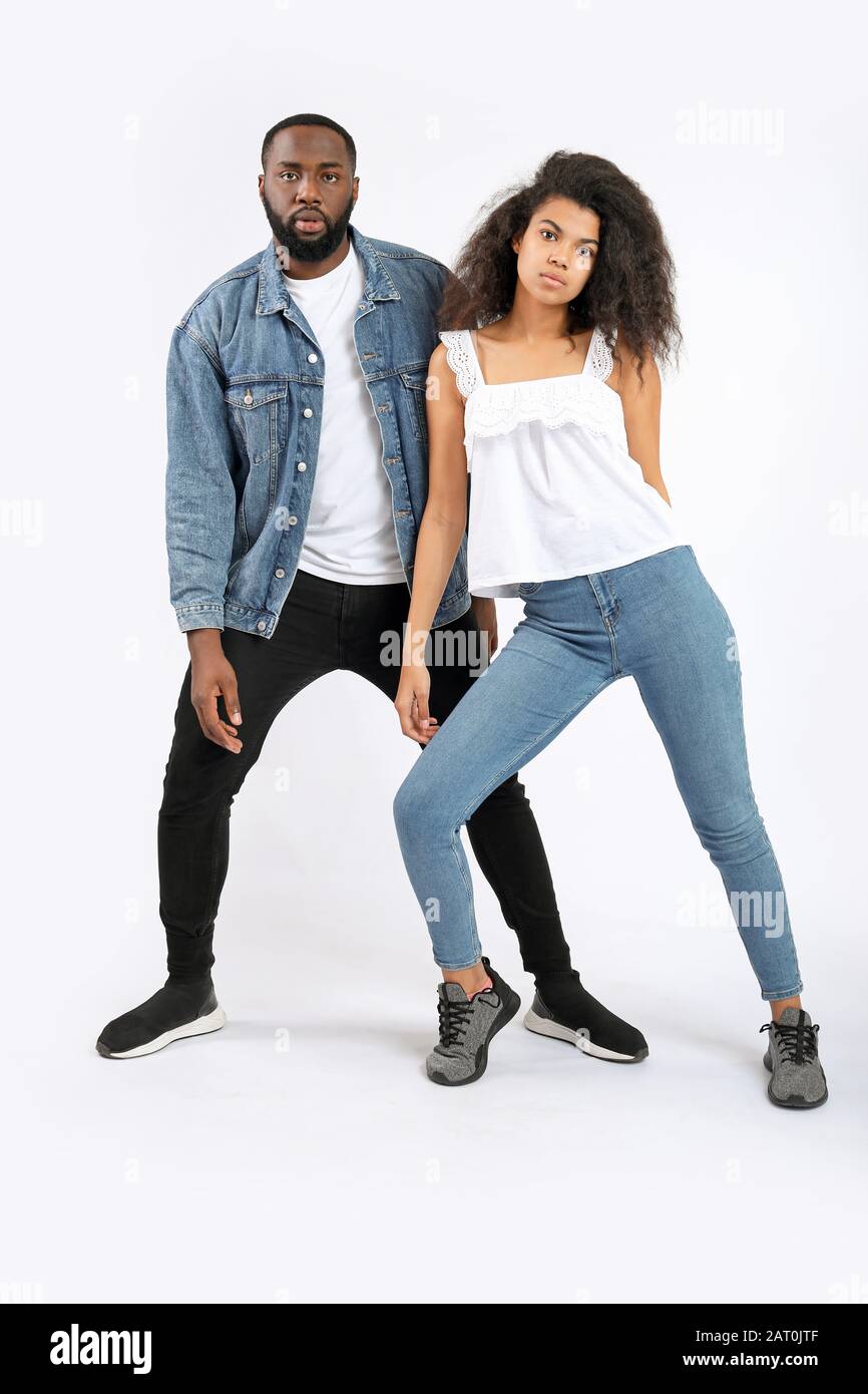 Portrait of stylish young African-American couple on white background ...