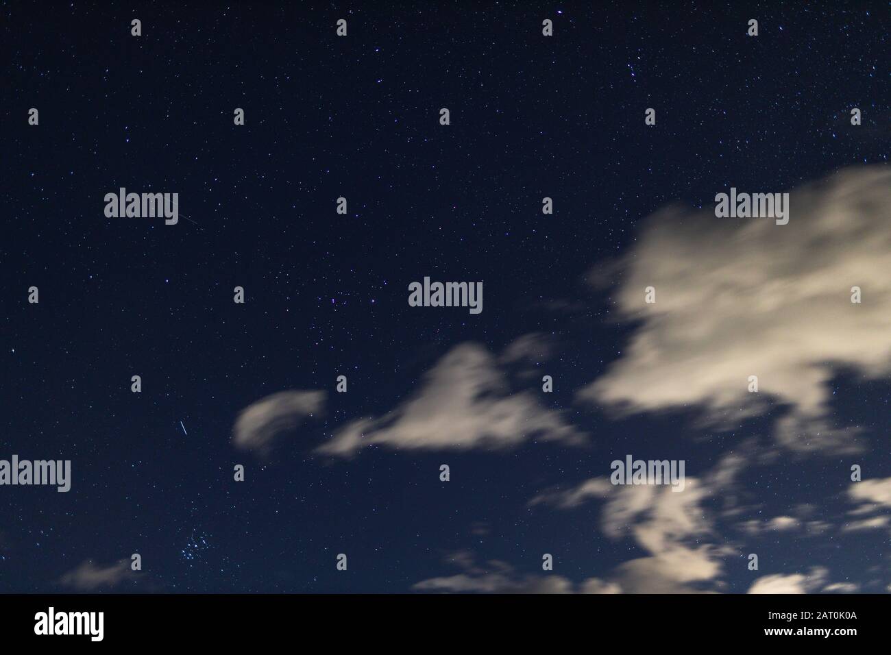 starry night with crisp sky and some clouds with a lot of ...