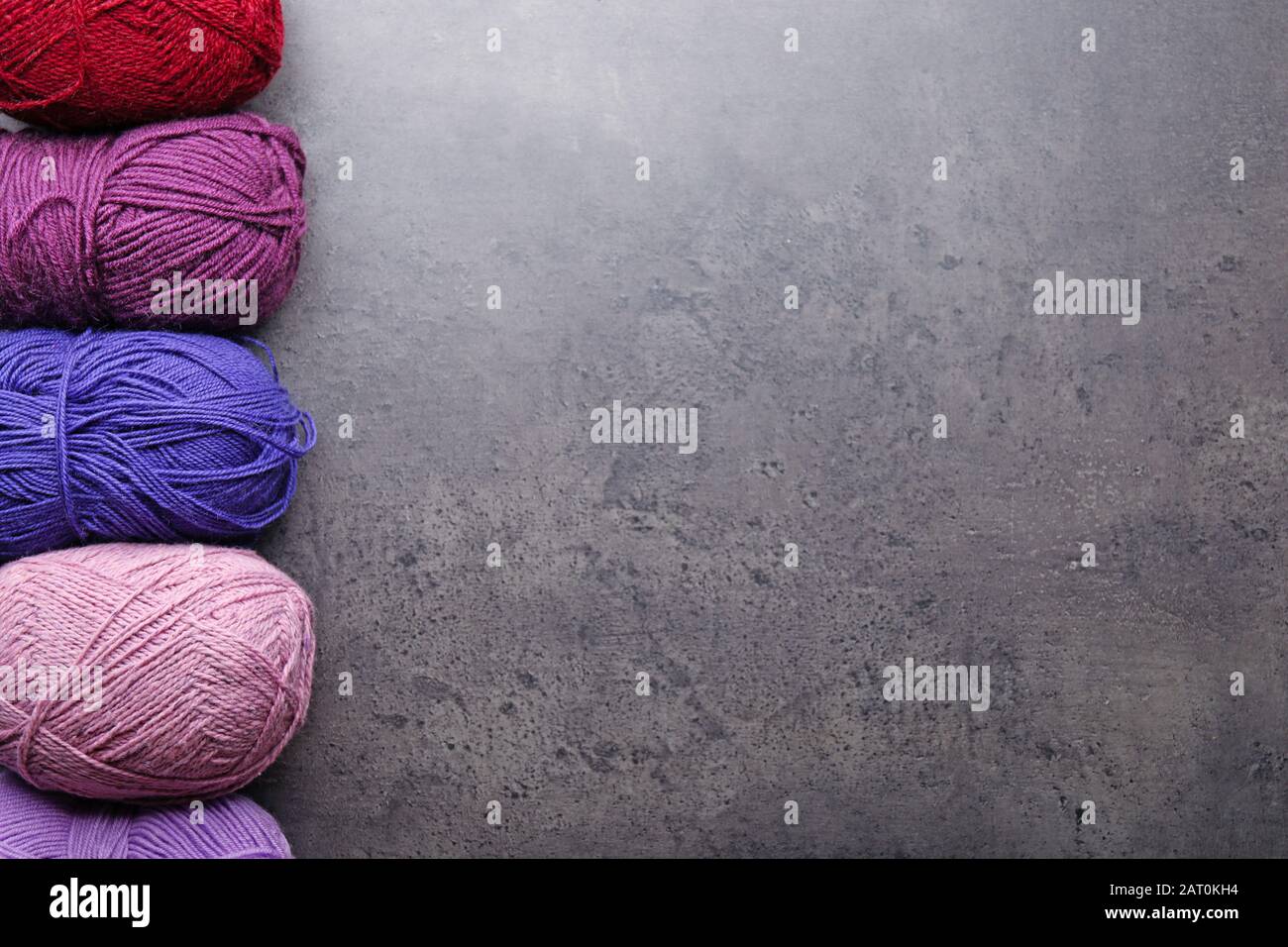 Colorful knitting yarns on grey background Stock Photo
