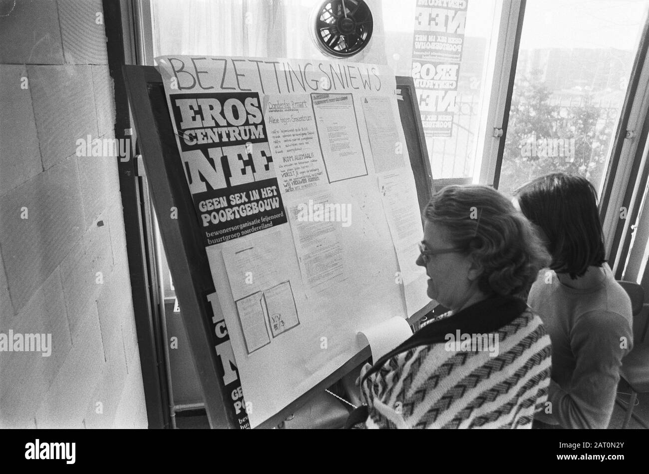 Occupation of the party office of the PvdA in Rotterdam in protest against the establishment of an erocentre in the Goortgebouw  A visitor reads pamphlets about the occupation Date: March 6, 1979 Location: Rotterdam, Zuid-Holland Keywords: occupation, pamphlets, party offices, protests Stock Photo