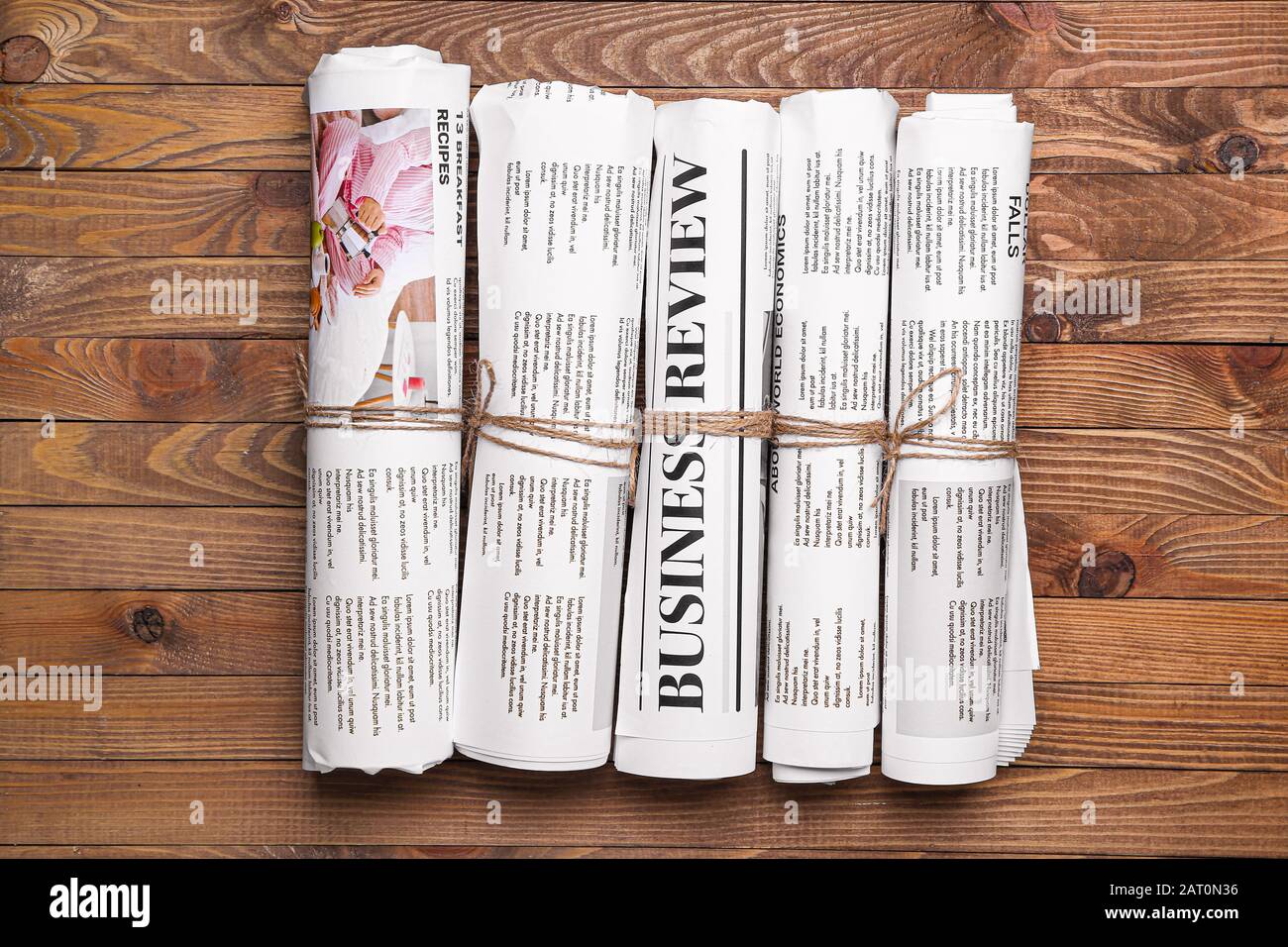 Many newspapers on wooden background Stock Photo