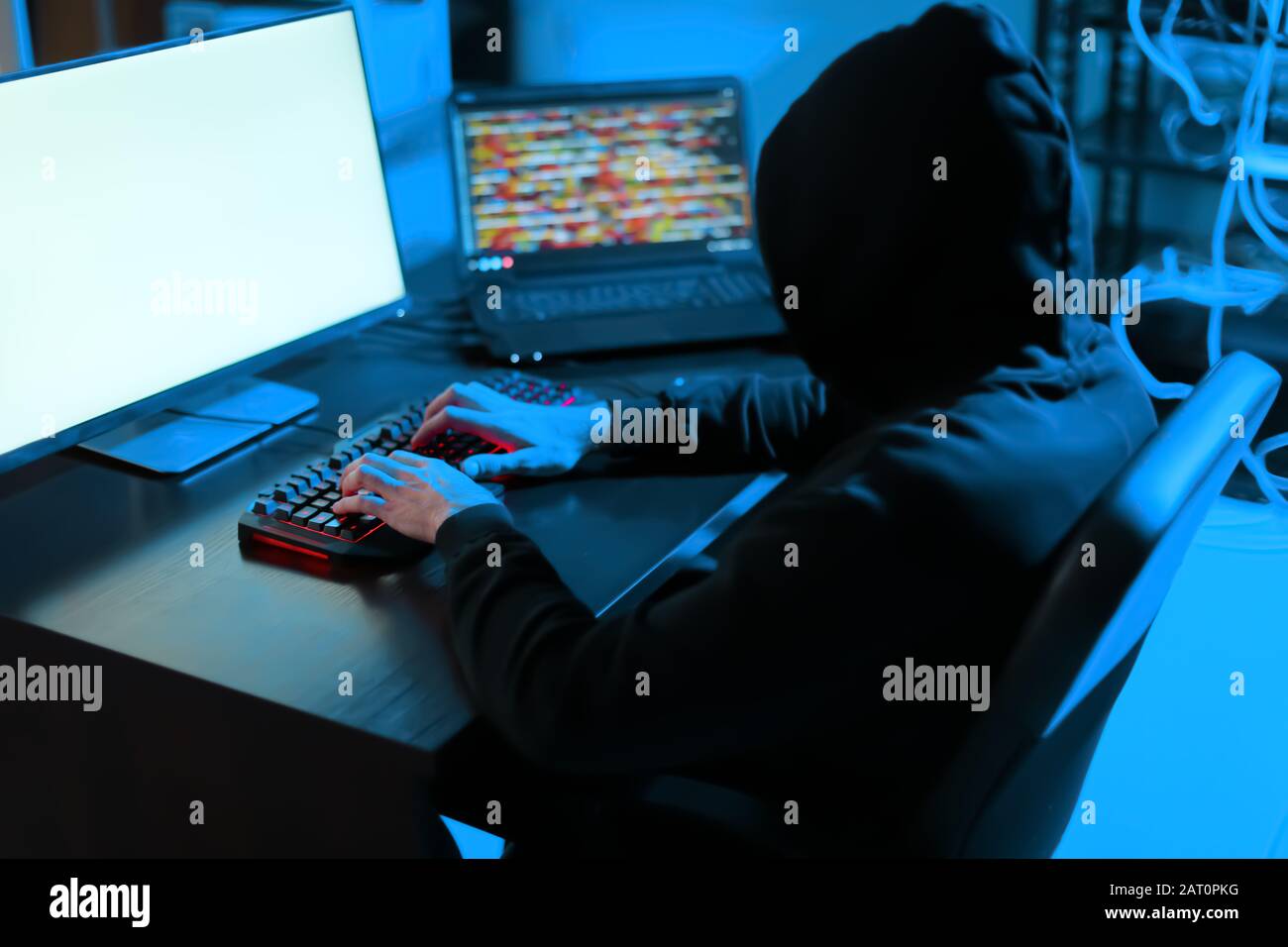 Professional hacker using computer in dark room Stock Photo - Alamy