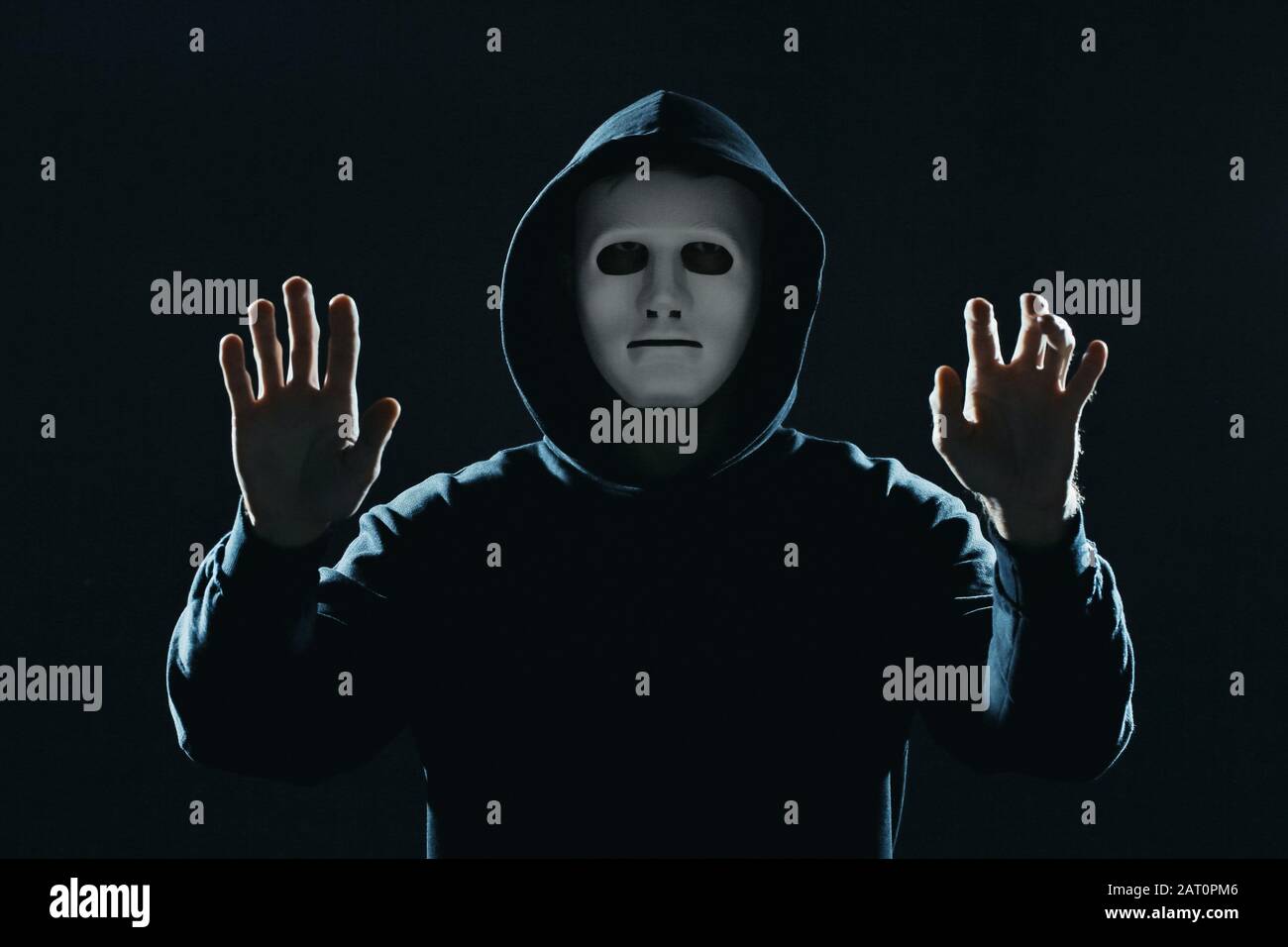 Professional hacker in mask on dark background Stock Photo