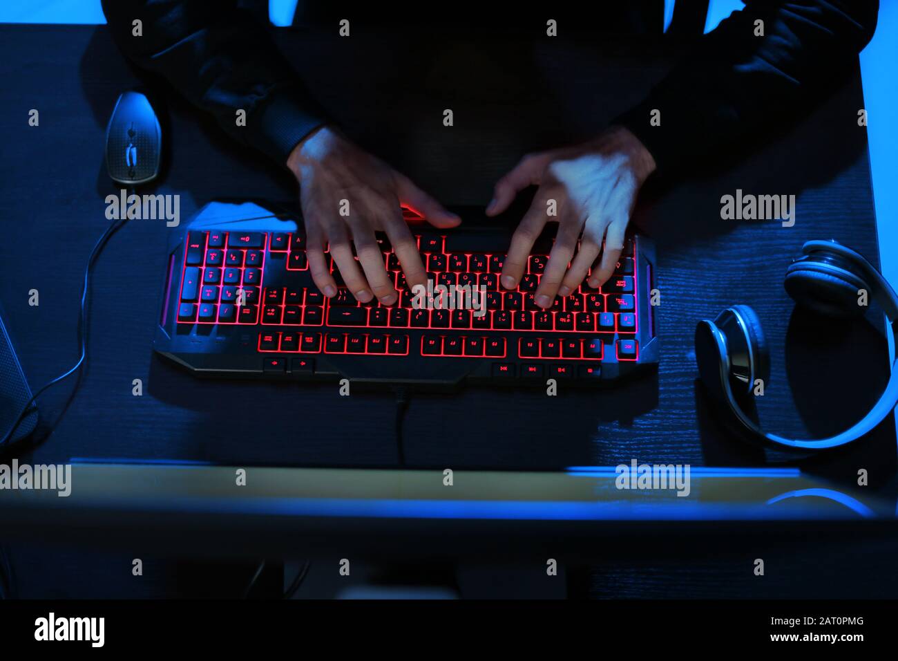 Professional hacker using computer in dark room Stock Photo - Alamy
