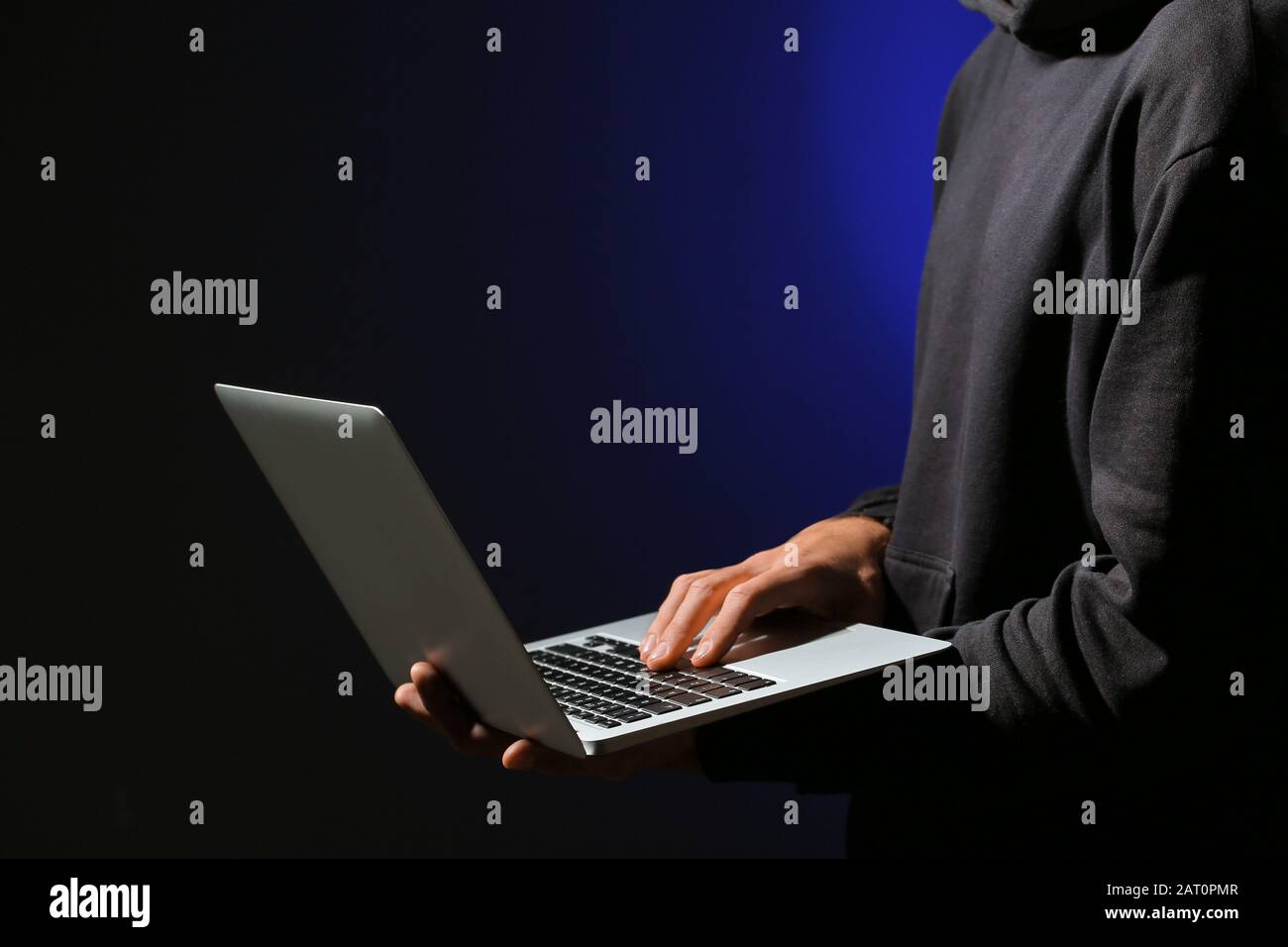 Professional hacker with laptop on dark background Stock Photo