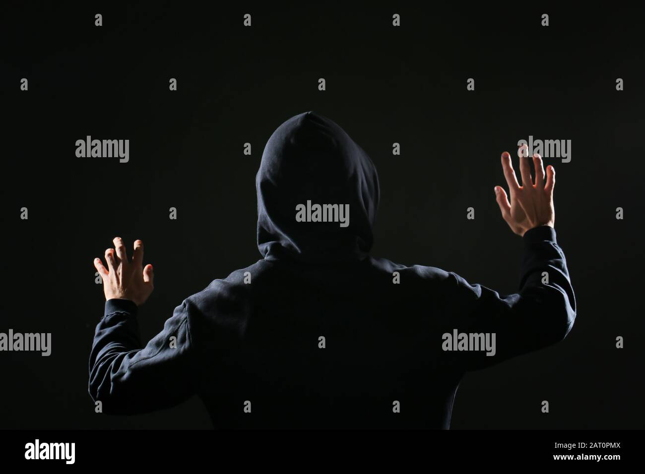 Professional hacker on dark background, back view Stock Photo