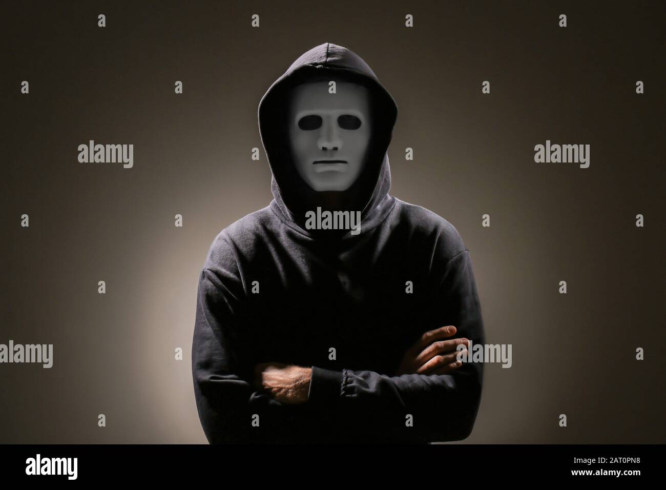 Professional hacker in mask on dark background Stock Photo