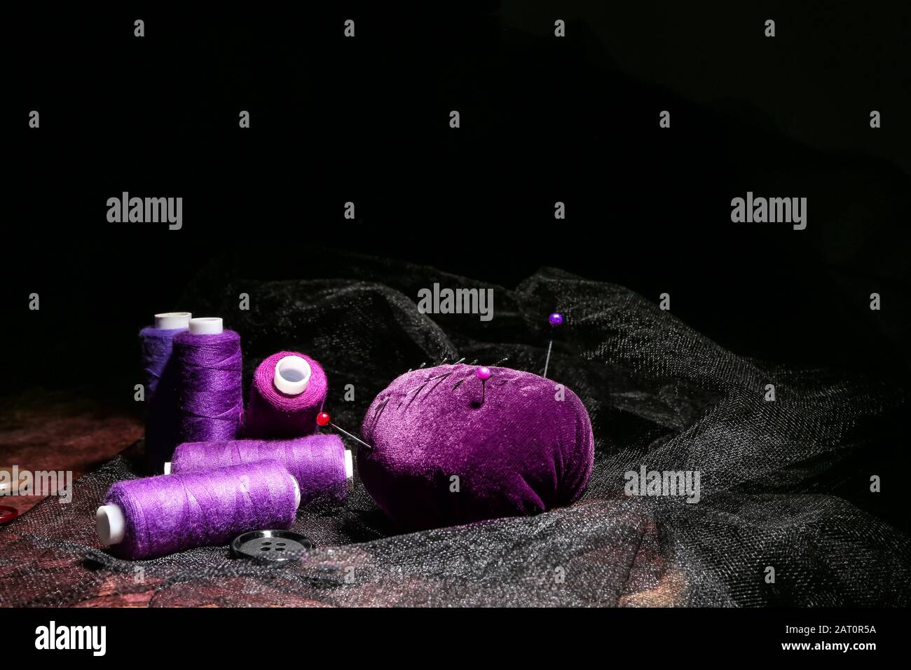 Set of tailor's supplies on dark background Stock Photo