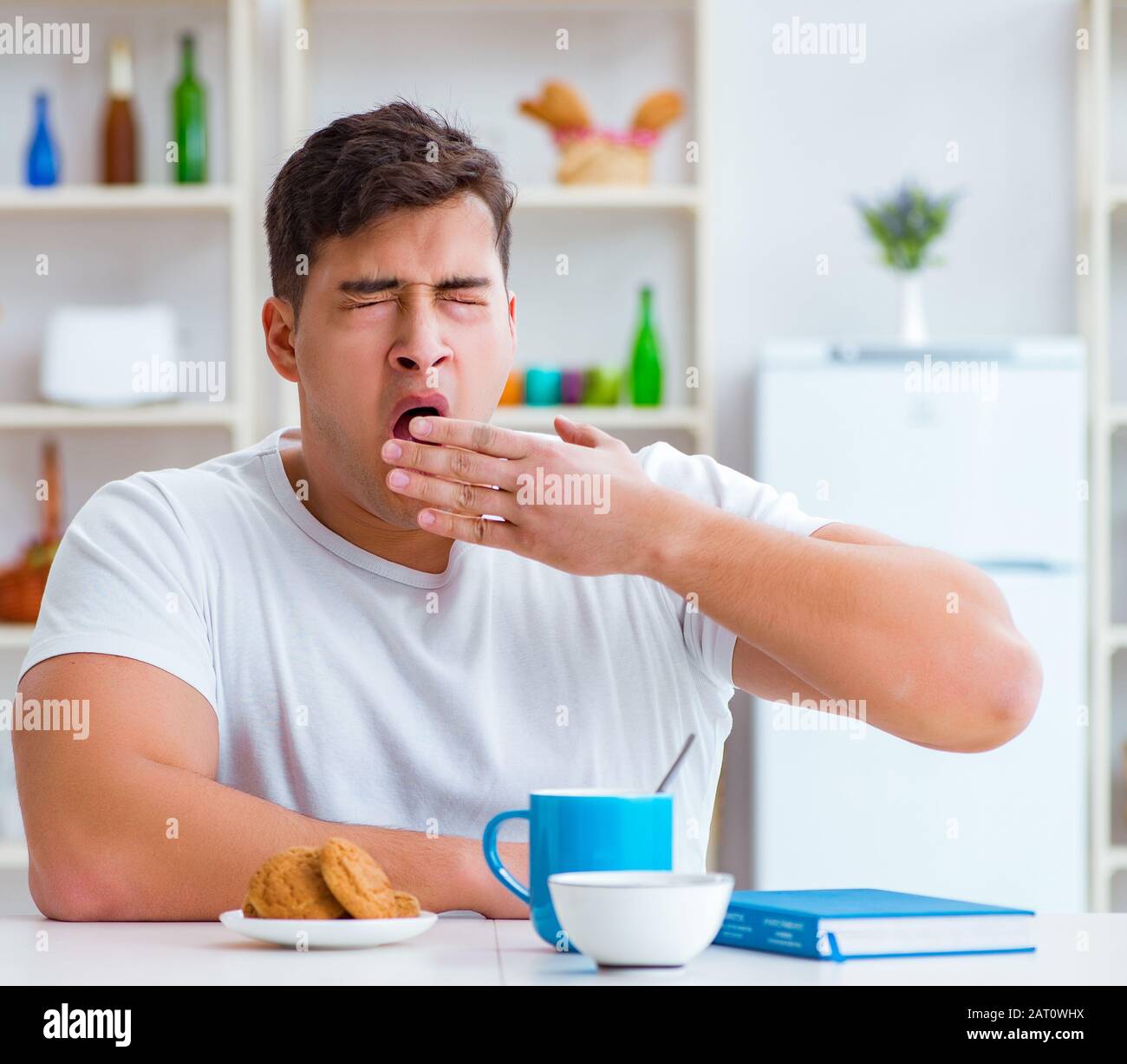 The man falling asleep during his breakfast after overtime work Stock
