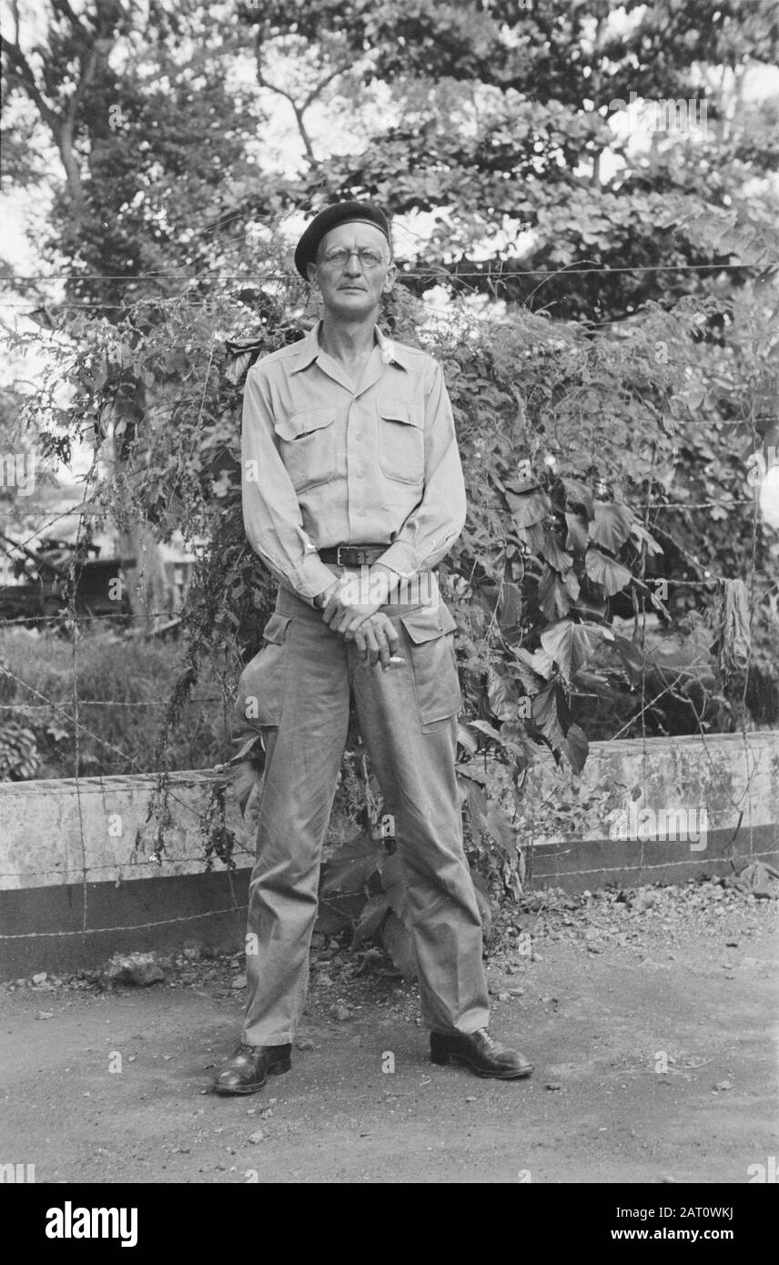 A man in uniform poses. He wears glasses and dark beret Date: april 1947 Location: Indonesia, Dutch East Indies Keywords: portraits Stock Photo