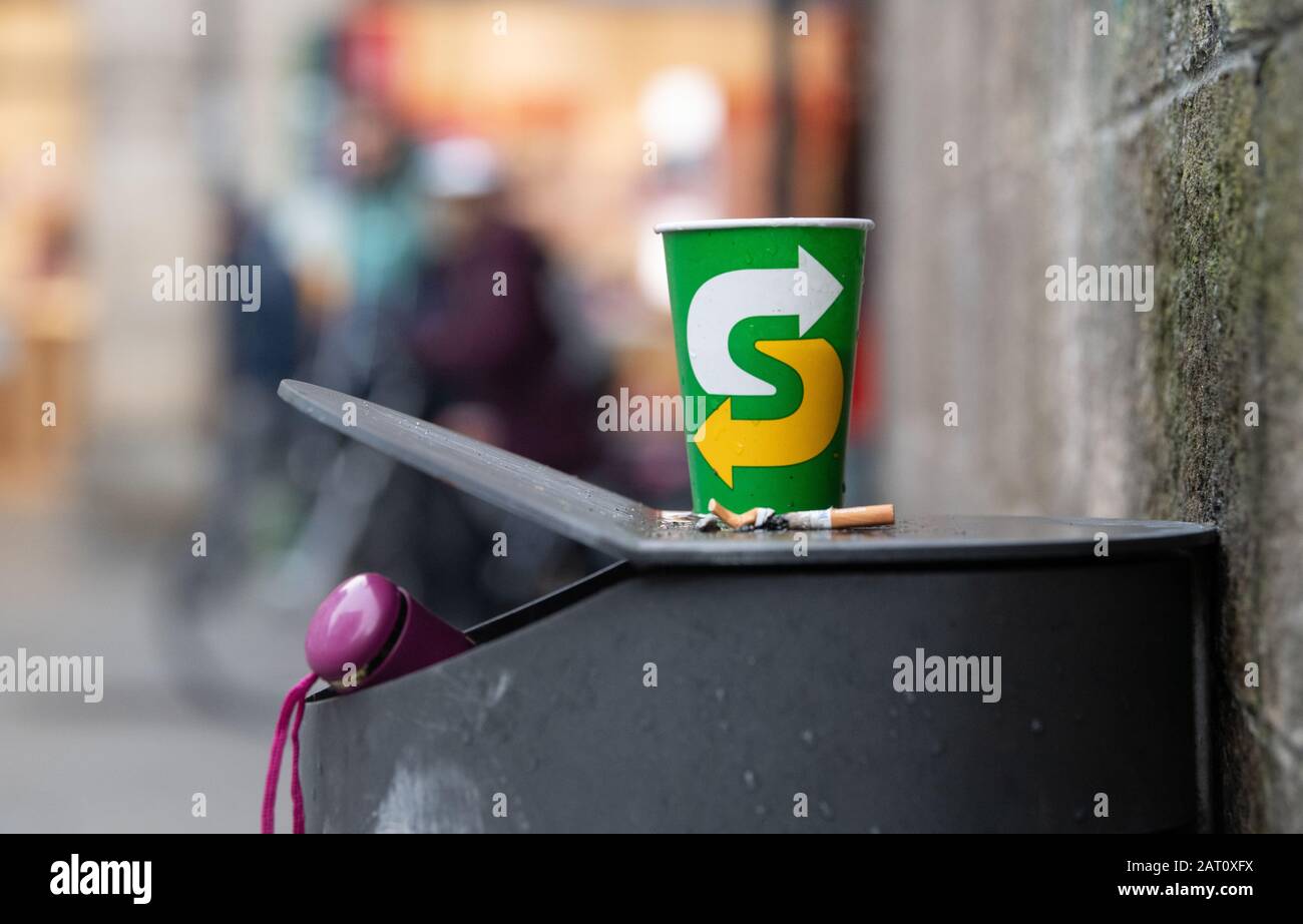 28 January 2020, Tübingen: A paper cup stands on a trash can near the ...