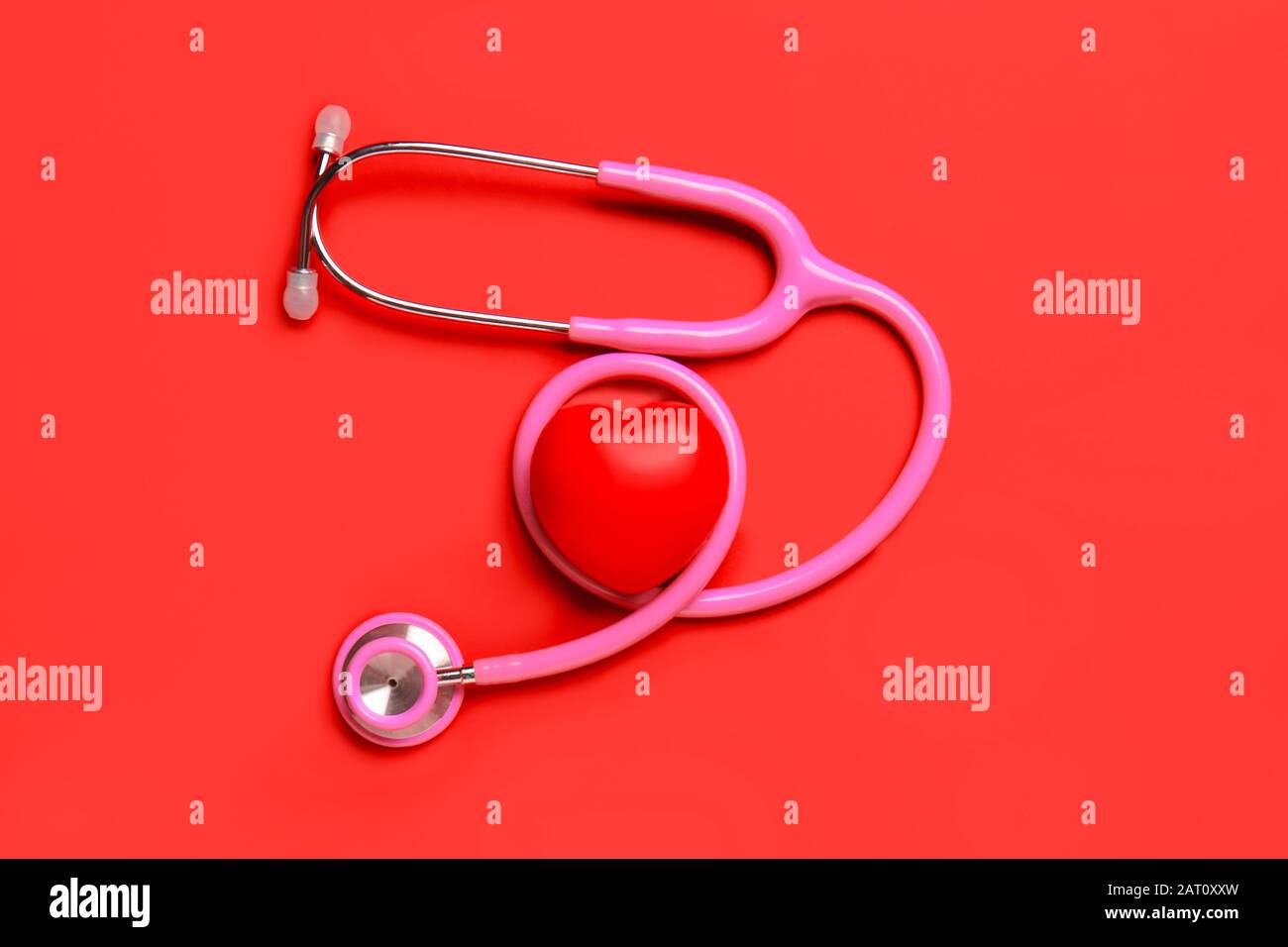 Modern stethoscope and red heart on color background Stock Photo - Alamy