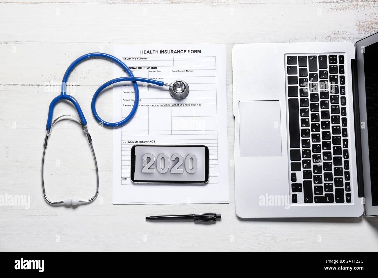 Laptop, stethoscope, mobile phone and health insurance form on white table  Stock Photo - Alamy