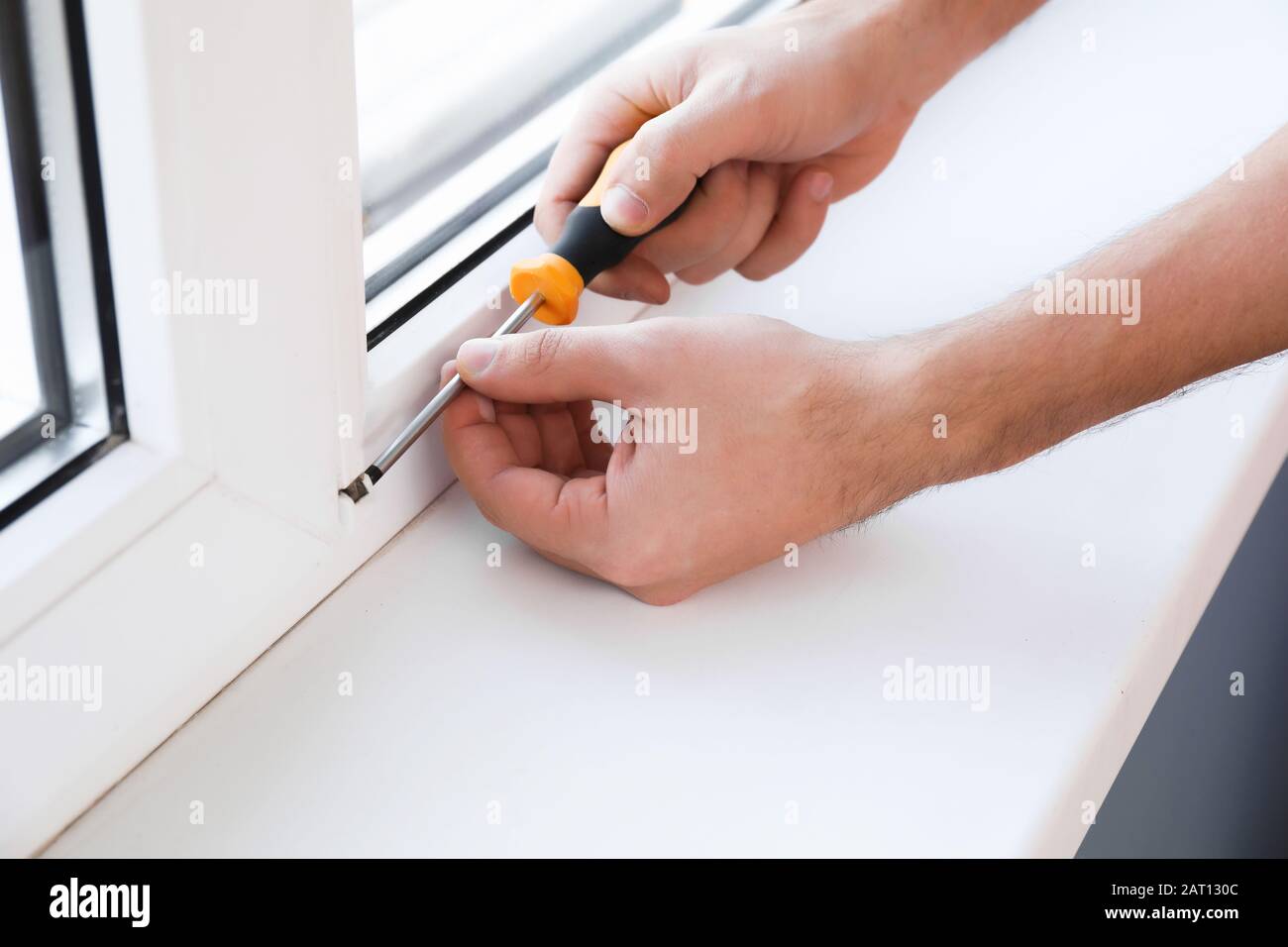 Window Apprentice Male worker installing window in flat, closeup Stock Photo - Alamy