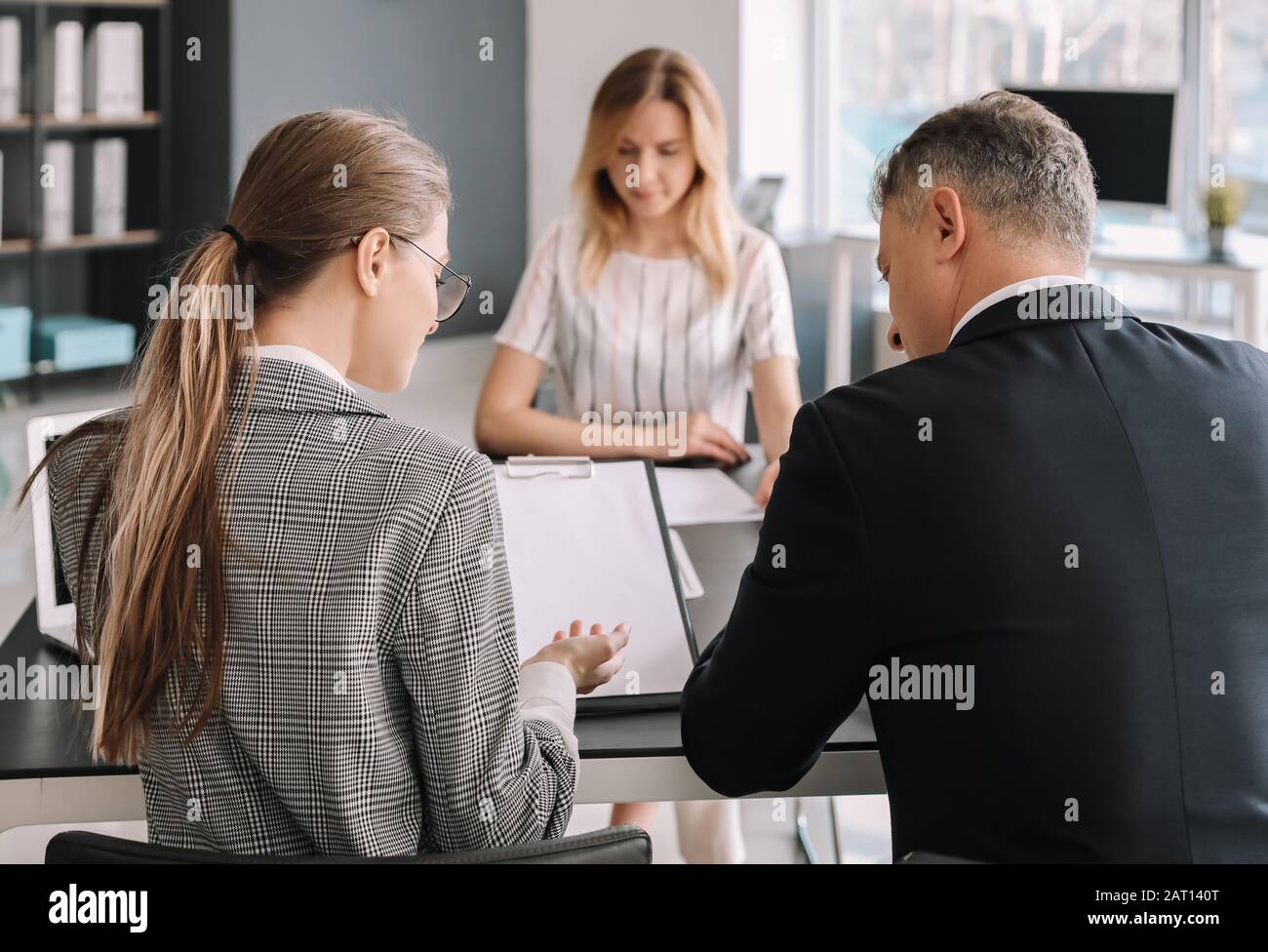 Human resources commission interviewing woman in office Stock Photo - Alamy