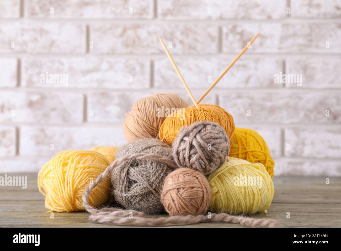 Knitting yarns with needles on table Stock Photo