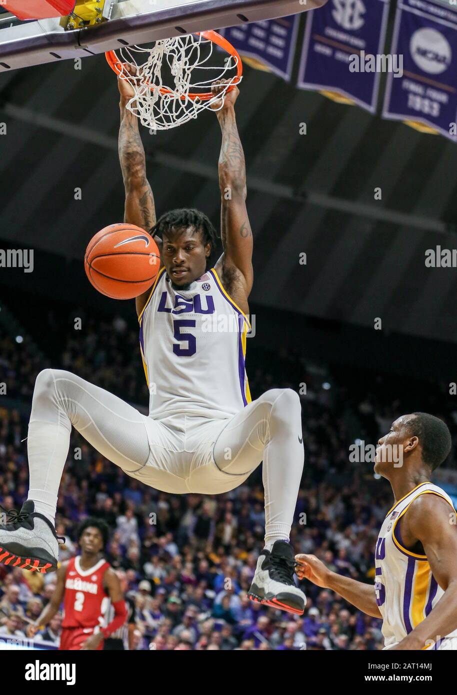 Baton Rouge, LA, USA. 29th Jan, 2020. LSU's Emmitt Williams (5) hangs on the rim after a big dunk during NCAA Basketball action between the Alabama Crimson Tide and the LSU Tigers at the Pete Maravich Assembly Center in Baton Rouge, LA. Jonathan Mailhes/CSM/Alamy Live News Stock Photo